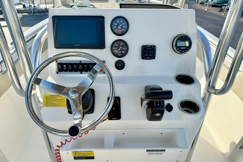 Slide: The Image of 2024 Key West 203 FS boat dashboard with steering wheel and control panel. - 3