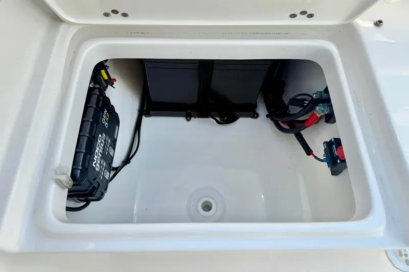 Slide: The Image of 2024 Key West 203 FS boat battery compartment with wiring and components. - 30