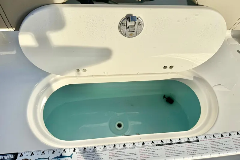 Slide: The Image of Livewell on 2024 Key West 203 FS boat, open lid, filled with water. - 31