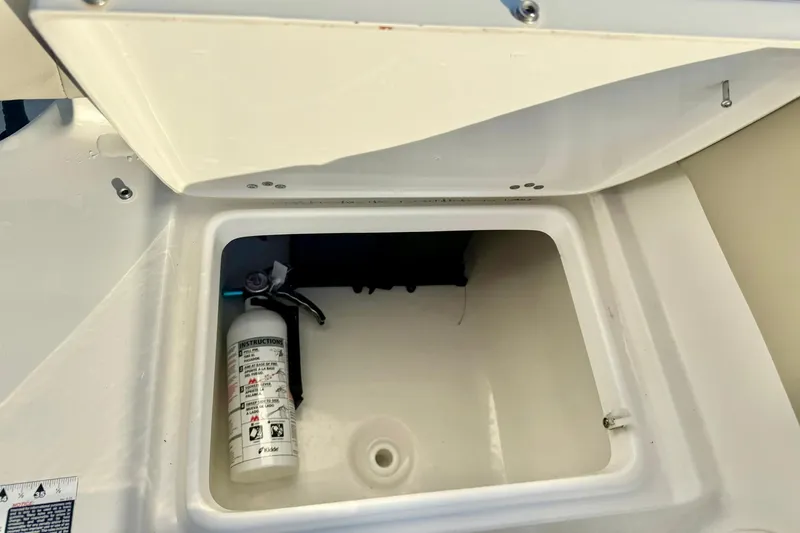 Slide: The Image of Open storage compartment in 2024 Key West 203 FS boat with fire extinguisher. - 32