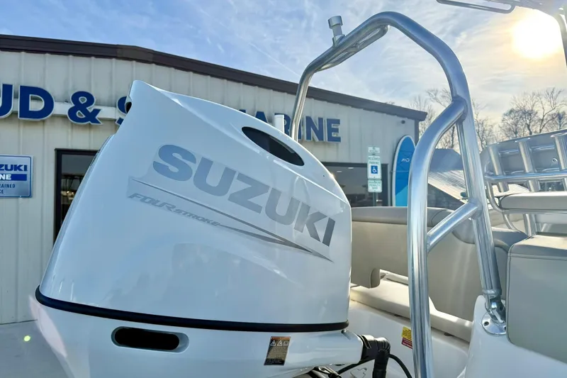 Slide: The Image of 2024 Key West 203 FS boat with Suzuki four-stroke engine at a marine dealership. - 39