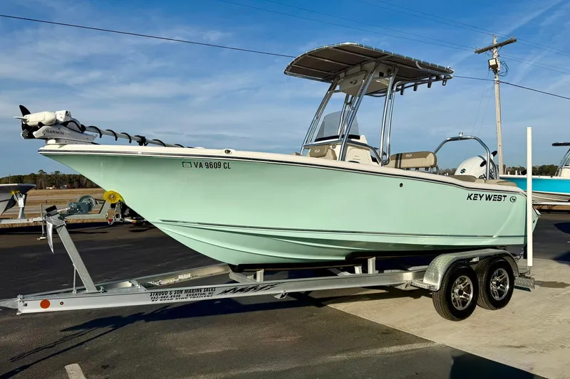 Slide: The Image of 2024 Key West 203 FS boat on trailer, light blue hull, parked outdoors. - 5