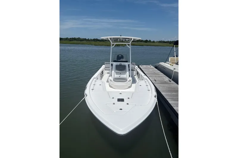 The Image of 2025 NauticStar 214 Shallow Bay boat docked on calm water. - 1