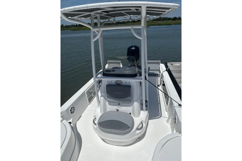 Slide: The Image of 2025 NauticStar 214 Shallow Bay boat with T-top on calm water. - 6