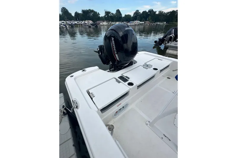 Slide: The Image of 2025 NauticStar 214 Shallow Bay boat with Mercury outboard engine on calm water. - 11