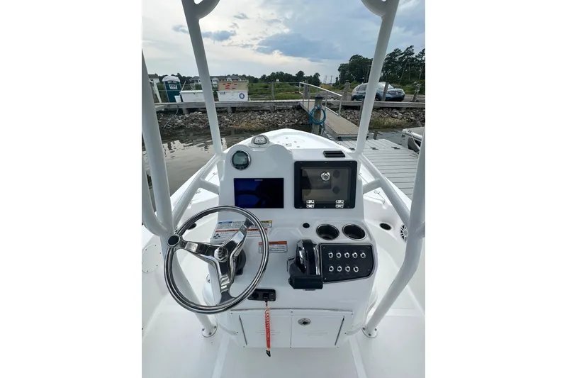 Slide: The Image of 2025 NauticStar 214 Shallow Bay boat console with steering wheel and controls. - 6