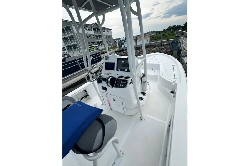 Slide: The Image of 2025 NauticStar 214 Shallow Bay boat interior with steering console and seating. - 9