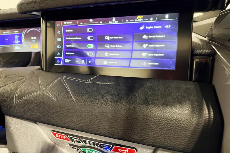 Slide: The Image of 2022 Nautique Super Air Nautique G23 Paragon dashboard with touchscreen controls and leather detailing. - 10