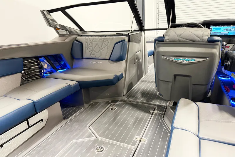 Slide: The Image of 2022 Nautique Super Air Nautique G23 Paragon interior with blue LED lighting and luxury seating. - 12
