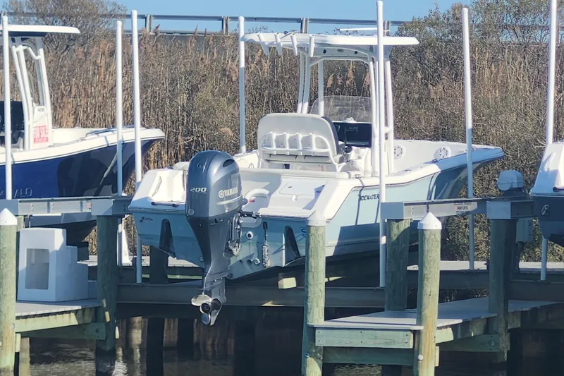 Slide: The Image of 2022 Tidewater 220 LXF boat docked with Yamaha outboard motor. - 2