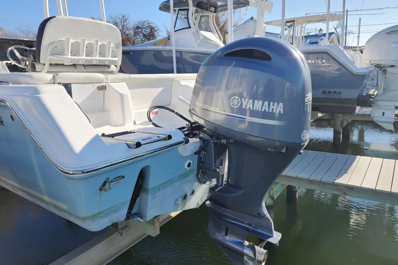 Slide: The Image of 2022 Tidewater 220 LXF boat with Yamaha outboard motor, docked on a sunny day. - 8