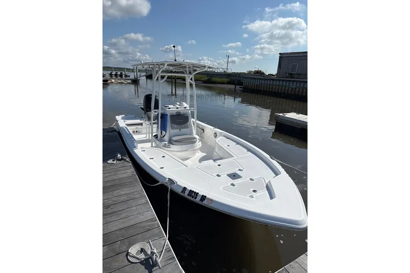 The Image of 2025 NauticStar 214 Shallow Bay boat docked on a sunny day. - 1