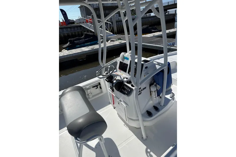 Slide: The Image of 2025 NauticStar 214 Shallow Bay boat console with steering wheel and controls. - 3