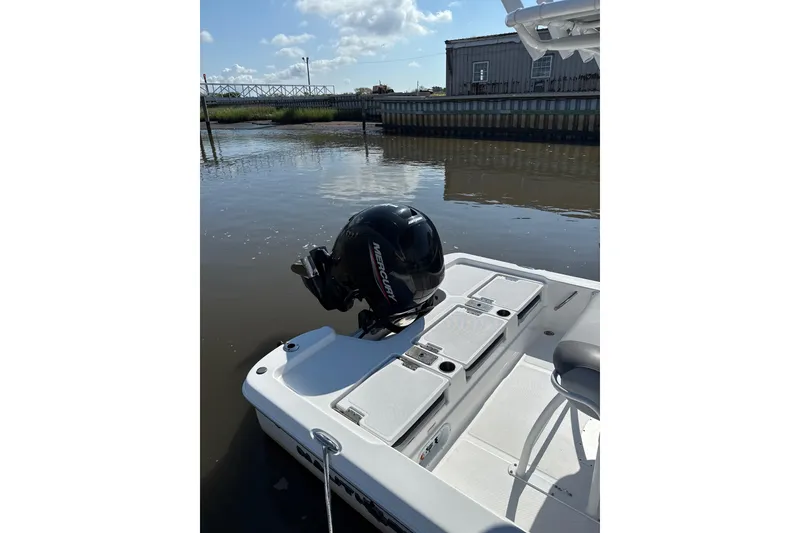 Slide: The Image of 2025 NauticStar 214 Shallow Bay boat with Mercury engine on calm water. - 7