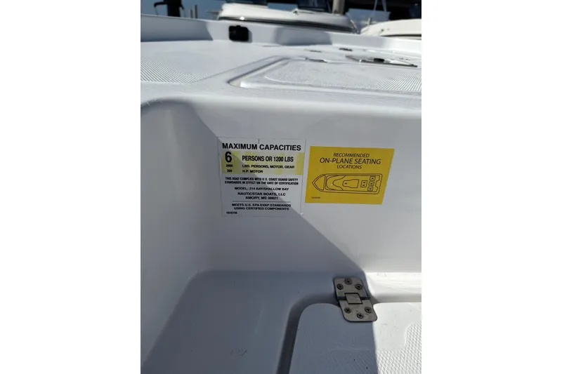 Slide: The Image of 2025 NauticStar 214 Shallow Bay boat capacity label, seating recommendations, and safety information. - 8