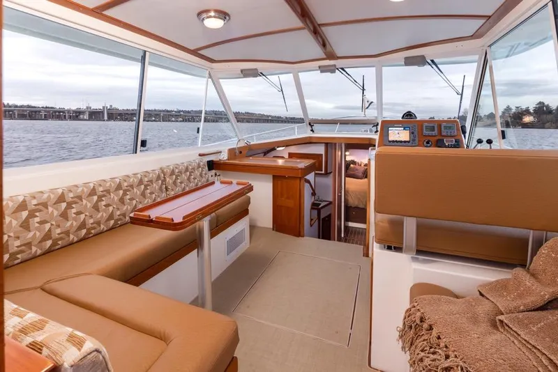 Slide: The Image of Interior of 2007 Bruckmann BLUESTAR boat with elegant seating and navigation area. - 10