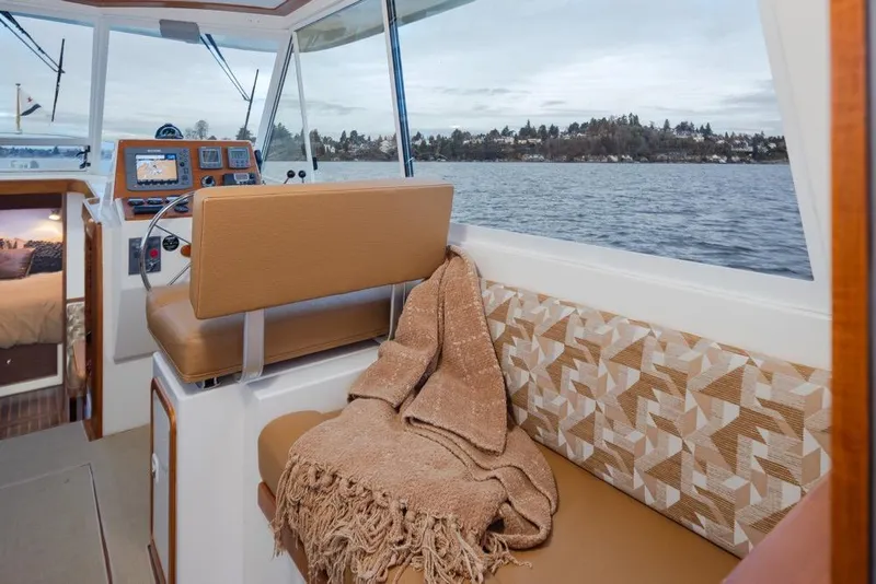 Slide: The Image of Interior of 2007 Bruckmann BLUESTAR boat with cozy seating and scenic water view. - 11