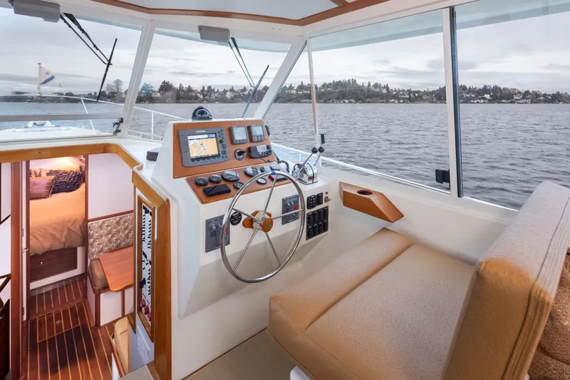 Slide: The Image of 2007 Bruckmann BLUESTAR boat interior with helm, navigation equipment, and cabin view. - 14