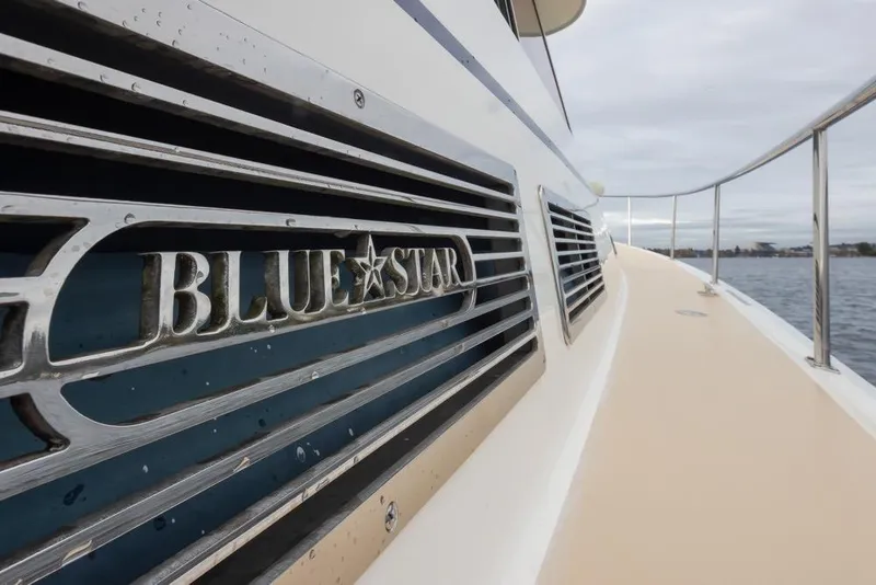 Slide: The Image of Close-up of 2007 Bruckmann BLUESTAR yacht nameplate on deck, near water. - 27