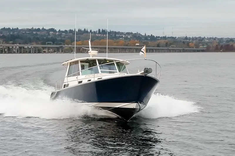 Slide: The Image of 2007 Bruckmann BLUESTAR boat cruising on a lake with scenic background. - 4