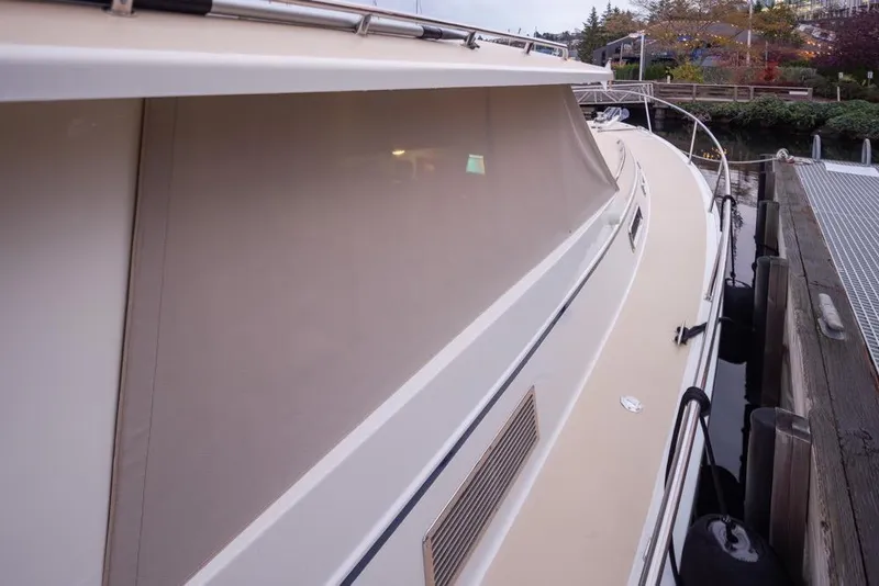 Slide: The Image of 2007 Bruckmann BLUESTAR yacht docked, side view with covered windows and sleek design. - 8