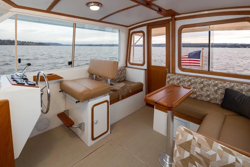 Slide: The Image of Interior of 2007 Bruckmann BLUESTAR boat with seating, table, and water view. - 9