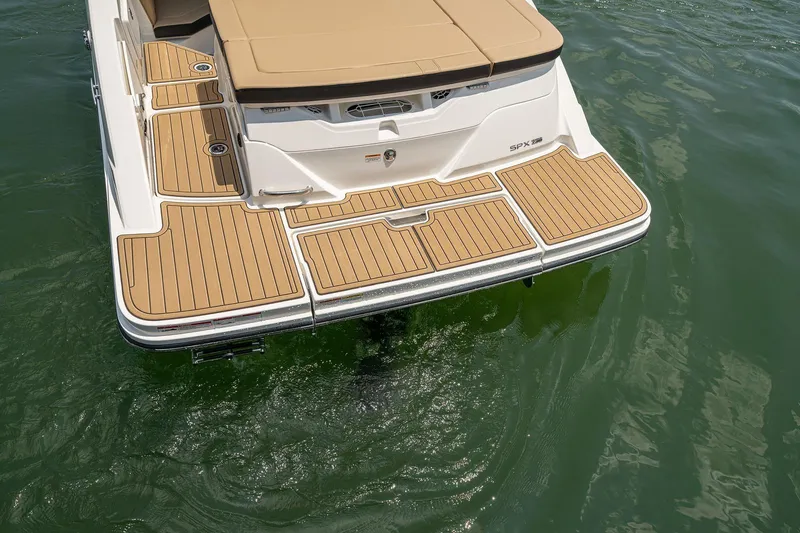 Slide: The Image of 2024 Sea Ray SPX 230 boat with teak swim platform on calm water. - 12