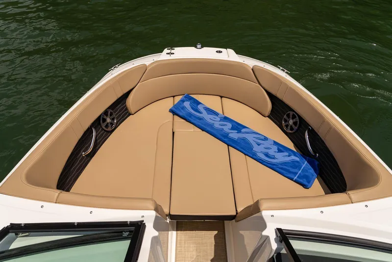 Slide: The Image of 2024 Sea Ray SPX 230 boat interior with tan seating and blue towel on water. - 14