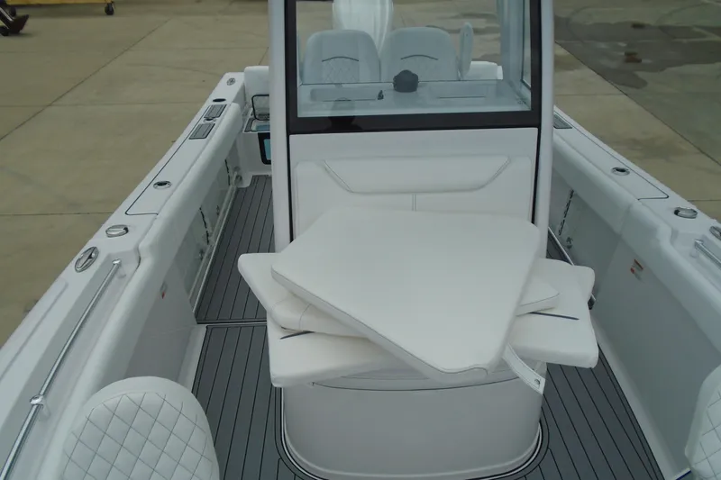 Slide: The Image of 2024 Sportsman Heritage 231 Center Console boat interior with cushioned seating and sleek design. - 16