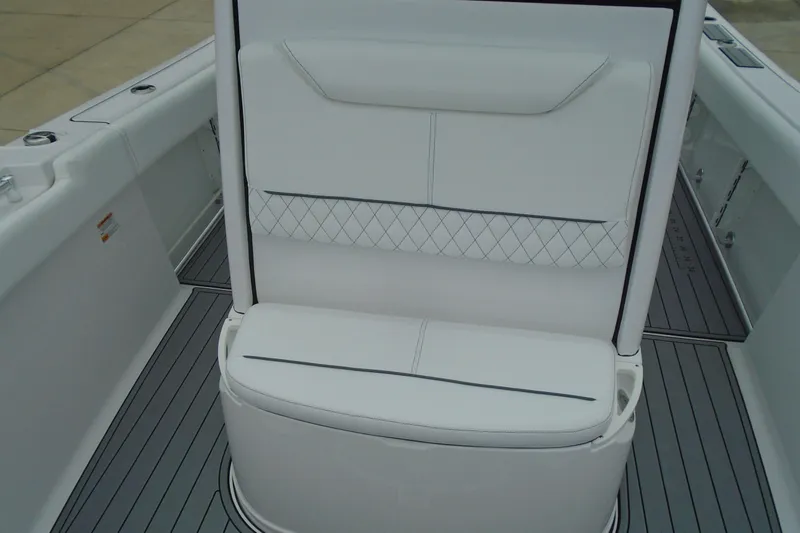 Slide: The Image of 2024 Sportsman Heritage 231 Center Console boat seat with white upholstery and diamond stitching. - 19