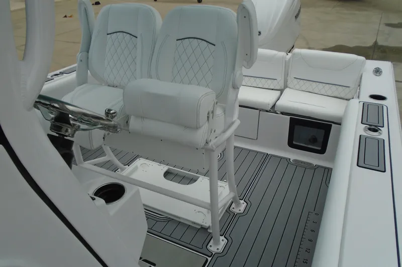 Slide: The Image of 2024 Sportsman Heritage 231 Center Console boat interior with white seating and steering wheel. - 20