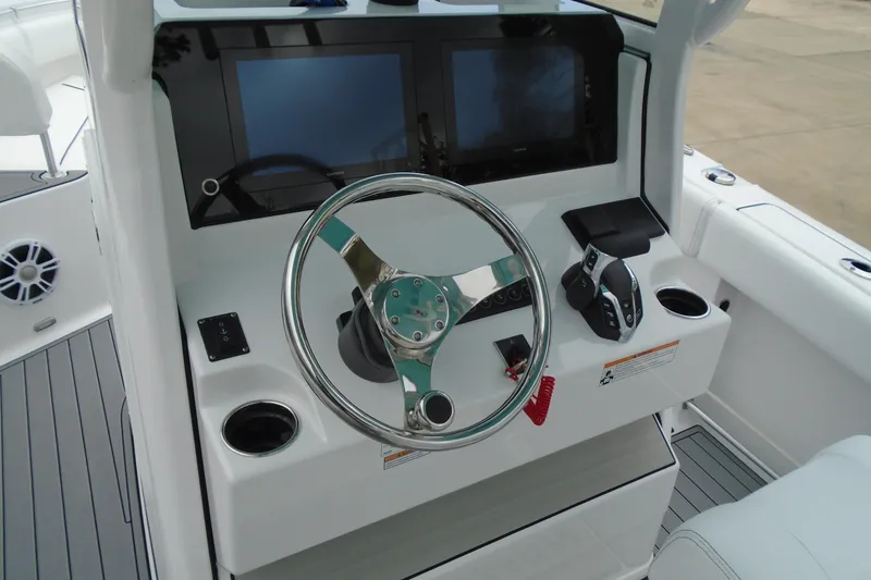 Slide: The Image of 2024 Sportsman Heritage 231 Center Console helm with dual screens and steering wheel. - 22