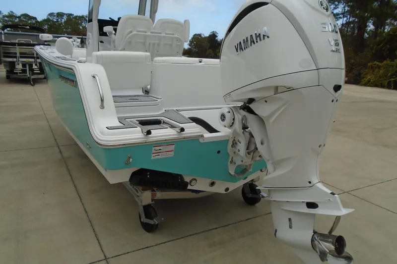 Slide: The Image of 2024 Sportsman Heritage 231 Center Console with Yamaha V6 outboard engine, teal hull. - 23