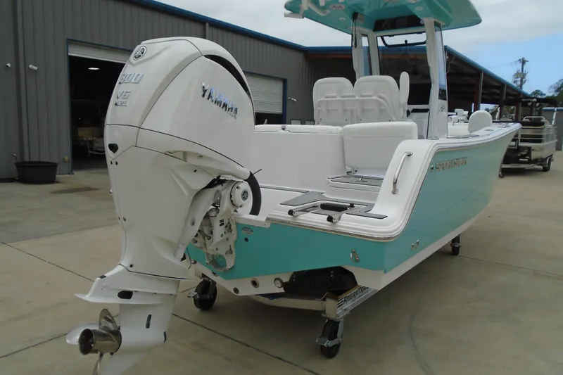 Slide: The Image of 2024 Sportsman Heritage 231 Center Console boat with Yamaha engine, parked outdoors. - 24