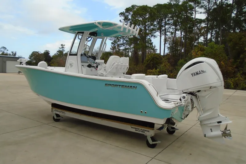 Slide: The Image of 2024 Sportsman Heritage 231 Center Console boat with Yamaha engine, parked outdoors. - 28
