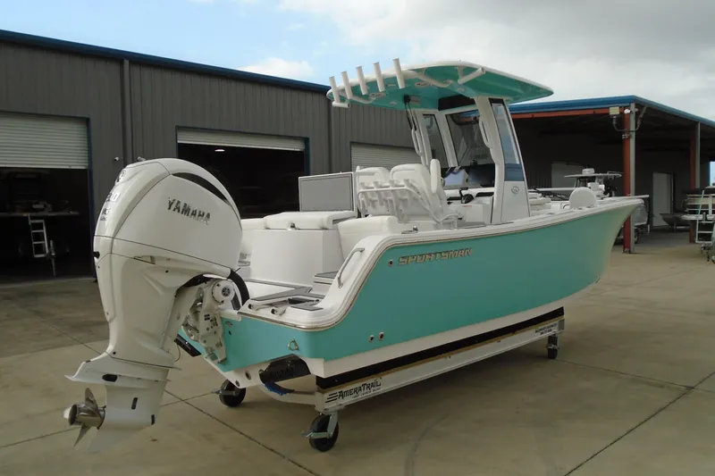 Slide: The Image of 2024 Sportsman Heritage 231 Center Console boat with Yamaha engine, parked outdoors. - 3