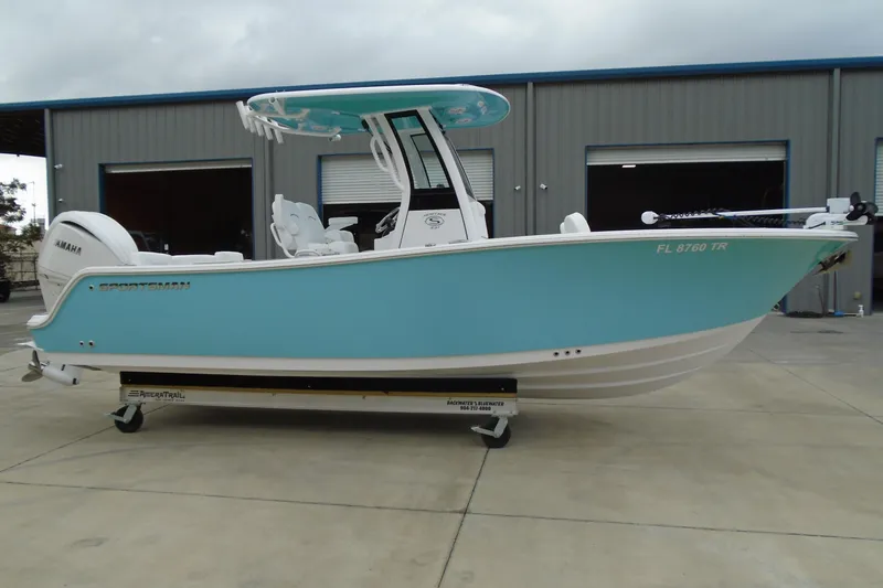 Slide: The Image of 2024 Sportsman Heritage 231 Center Console boat in light blue, parked on a trailer. - 31