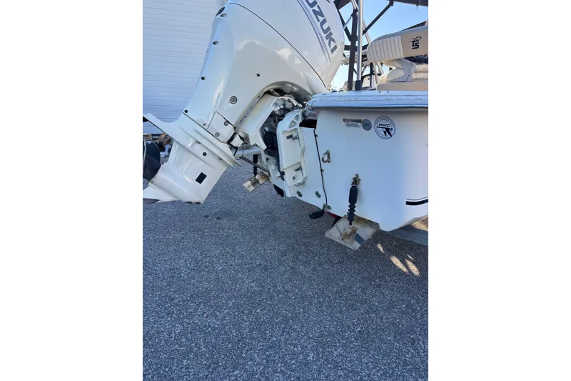 Slide: The Image of 2018 Carolina Skiff 18 JVX CC boat with Suzuki outboard motor, parked on pavement. - 9