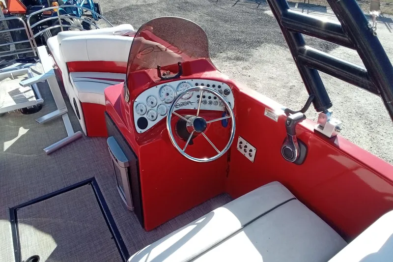 Slide: The Image of Red Razor 238 boat interior with steering wheel and seating, 2019 model. - 10