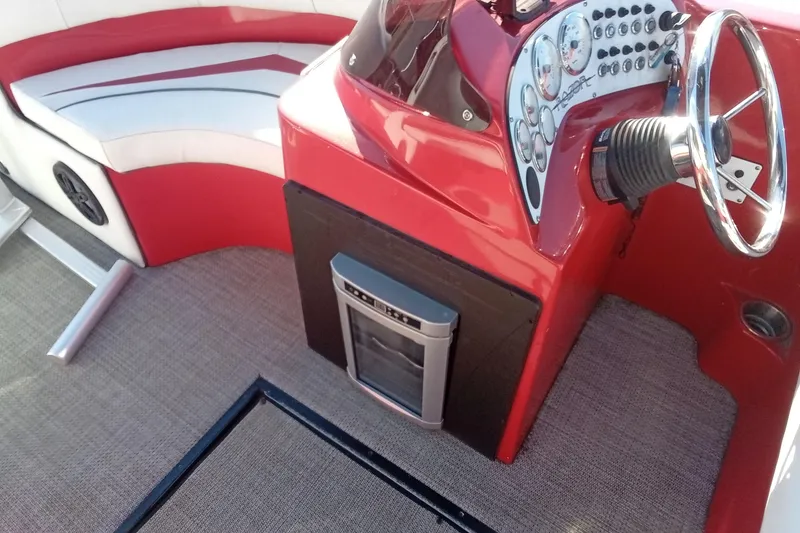 Slide: The Image of Red Razor 238 boat interior with steering wheel and seating, 2019 model. - 13