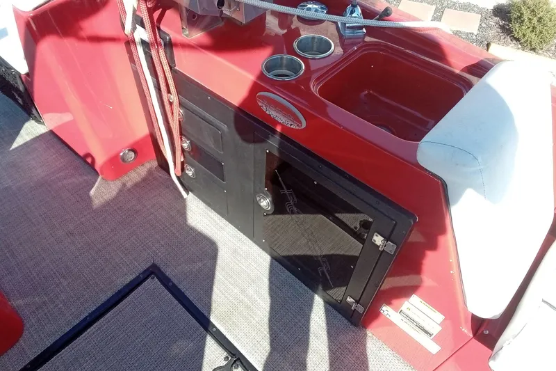 Slide: The Image of Red Razor 238 boat interior with storage compartments and cup holders, 2019 model. - 15