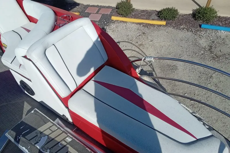 Slide: The Image of Red and white Razor 238 boat seat, 2019 model, with shadow and outdoor setting. - 17