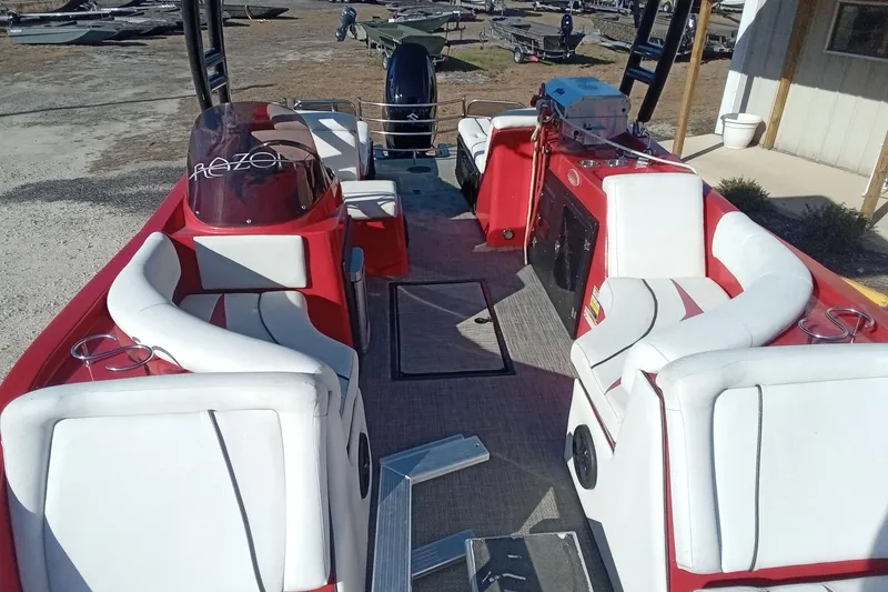 Slide: The Image of Red and white Razor 238 boat interior, 2019 model, with seating and helm. - 18