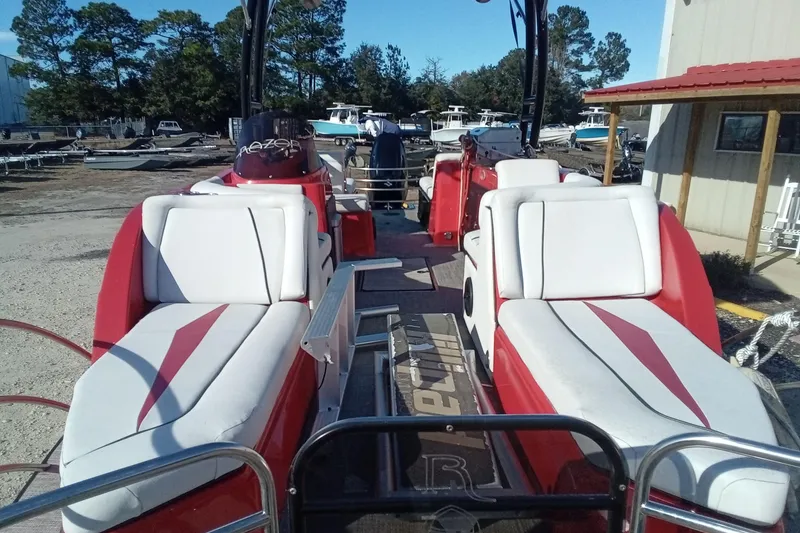 Slide: The Image of Red and white Razor 238 boat, 2019 model, with comfortable seating and outdoor setting. - 19