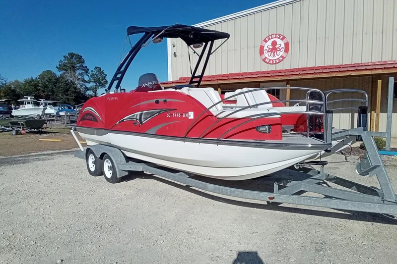 Slide: The Image of Red Razor 238 boat on trailer, parked outside a building, 2019 model. - 3