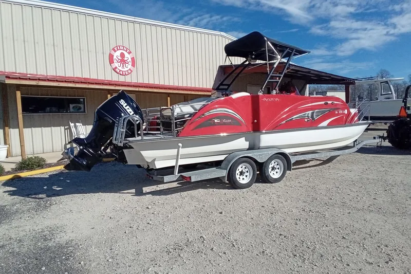 Slide: The Image of Red Razor 238 boat on trailer, parked outside a building, 2019 model. - 4