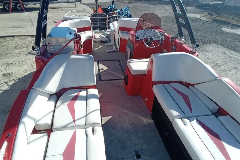Slide: The Image of Red and white Razor 238 boat interior, 2019 model, featuring spacious seating and modern dashboard. - 8