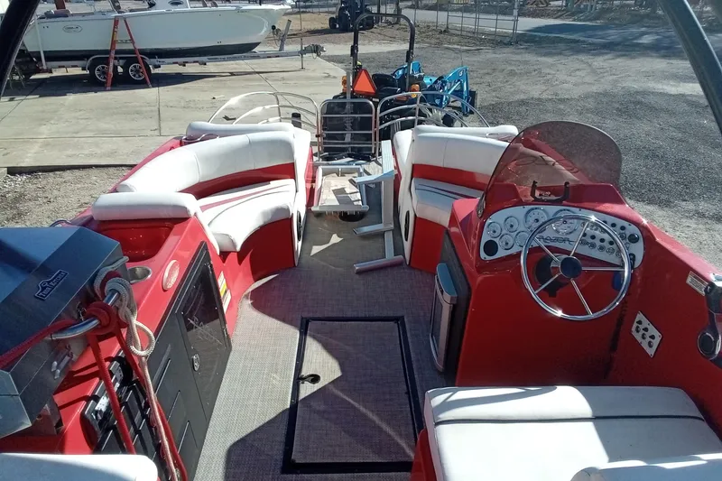 Slide: The Image of Red Razor 238 boat interior, 2019 model, featuring white seating and a steering console. - 9