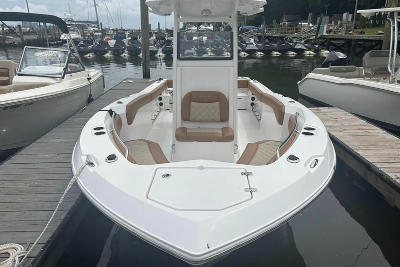 The Image of 2025 NauticStar 242L Offshore boat docked, featuring spacious seating and sleek design. - 1