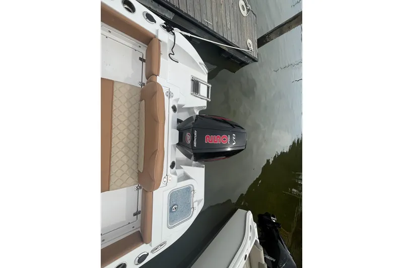 Slide: The Image of 2025 NauticStar 242L Offshore boat with Mercury V8 engine docked at marina. - 8